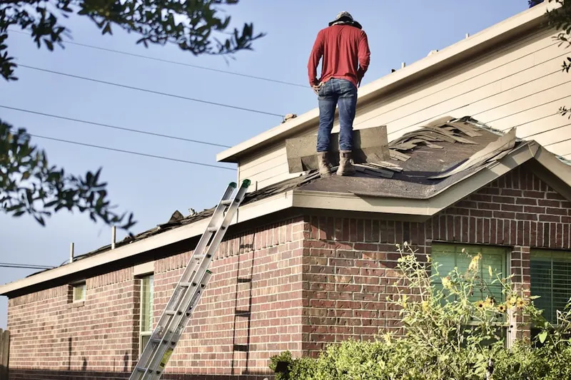 Professional roofer working on a residential roof in Oxbow